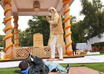Viral photograph of PM Narendra Modi and a photographer lying on the ground to click his picture was found to be a composite of two unrelated images.